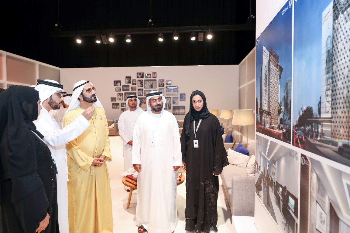 Association representatives presenting architectural designs at an event